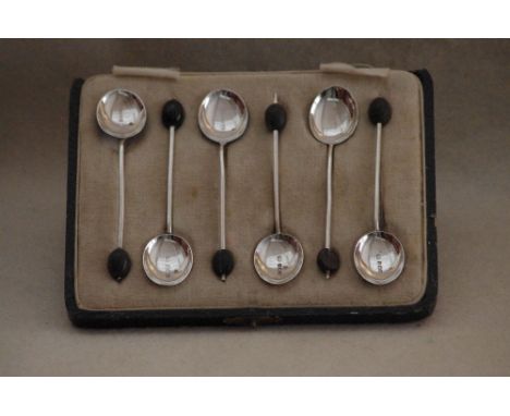 A cased set of six silver and enamel coffee bean teaspoons. Maker WILLIAM SUCKLING Ltd, Birmingham, 1928.