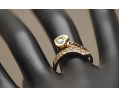 An unusual 14ct gold, ruby and diamond dress ring mounted in an Art Nouveau style setting. Approximate weight 6.1 grams. Size
