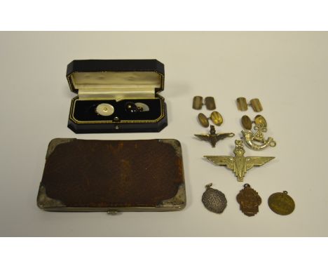 A pair of silver cufflinks; a silver mounted leather wallet; other cufflinks; cap badges; etc. 