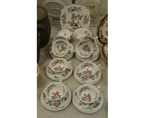 A Wedgwood floral/butterfly pattern part tea service , 10 cups and saucers, side plates, sucrier; bread and butter plate