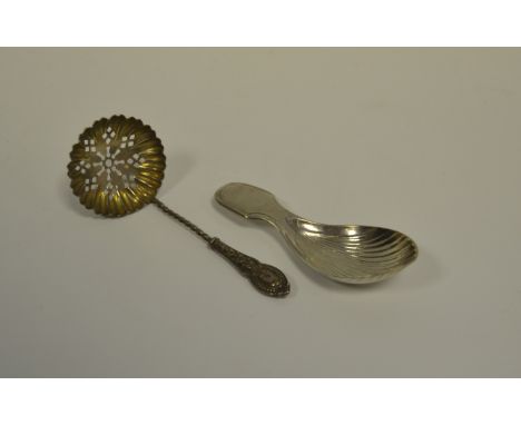 Silver -  a Victorian silver shell shape caddy spoon, Edinburgh 1861, 13.7g; a William Deakin sugar sifter, 8.9g (2)