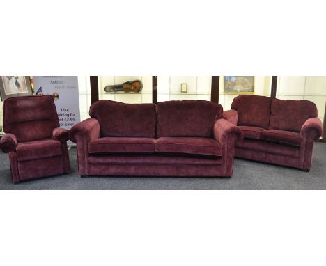 A contemporary  three-seat sofa, a two-seater, a  recliner, upholstered in plum coloured fabric