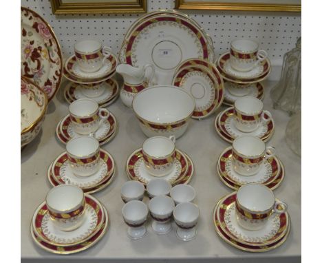 A late-19th century tea service, banded maroon border, comprising ten cups, two bread and butter plates, milk jug, slop bowl,