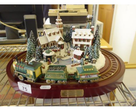 Thomas Kinkades, Christmas centre piece on an oval base, Home for the Holidays a model Village with Snow, Figures and Train, 