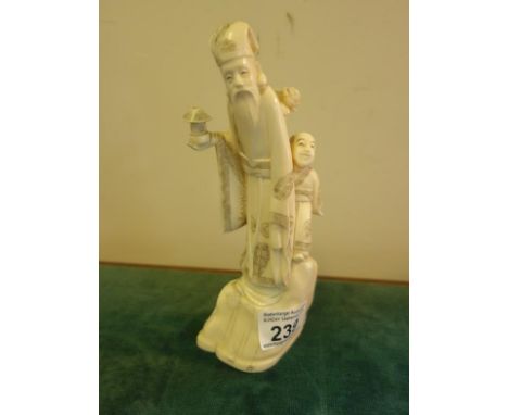 Signed ivory carved group, long bearded Man holding a lantern with a smaller Man behind him standing on a Rock, total height 