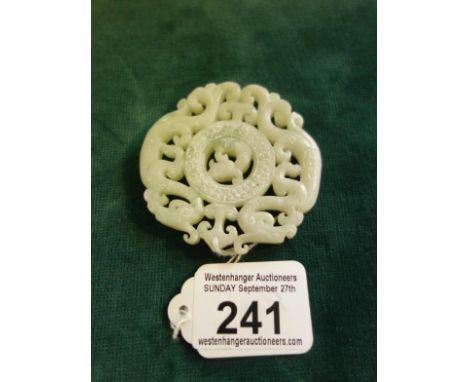 Celadon carved Jade item, circular, the centre section with a Fish, pierced carved decoration throughout, 2.3/4" dia,