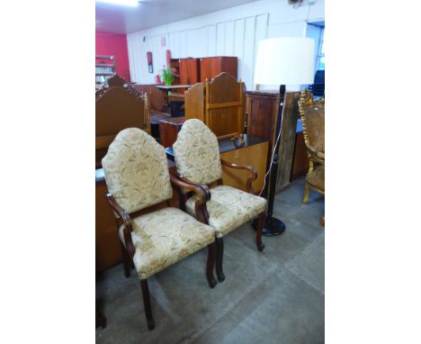 A pair of French mahogany and fabric upholstered armchairs and a standard lamp 