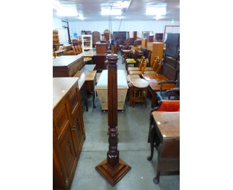 A carved mahogany floor standing lamp 