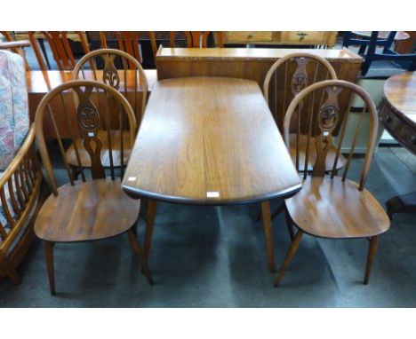 An Ercol Golden Dawn elm and beech Windsor drop leaf table and four chairs 