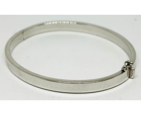 A contemporary hallmarked 9ct white gold bangle, approx. diam. 58mm, wt. 10.2g.  Condition - very good, no damage/repair, gen