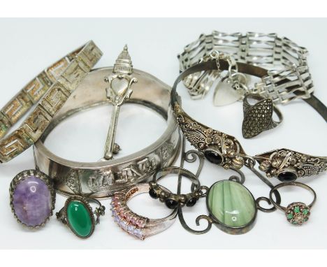 A mixed lot of hallmarked and other silver comprising two bangles, two bracelets, an Arts &amp; Crafts style pendant set with