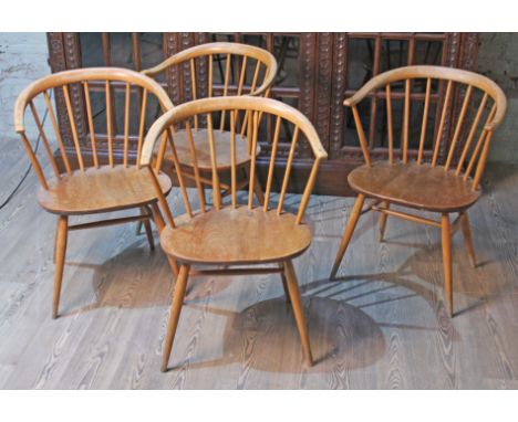 A set of four Ercol elm seated spindle back cow horn armchairs.Condition: various areas of wear to finish on backs, arms seat