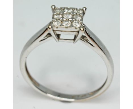 A 9ct white gold diamond cluster ring, comprising nine round brilliant cut diamonds, total approx. wt. 0.20 carats, band mark