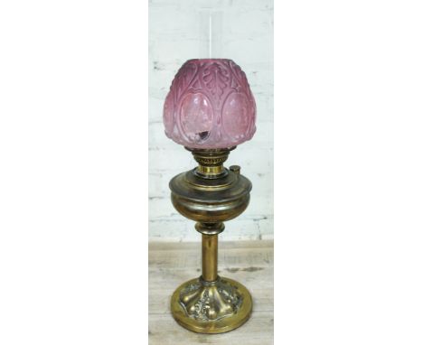 A Victorian brass oil lamp with etched cranberry glass shade, height 69cm.Condition: some signs of ware to brass , minor nigg