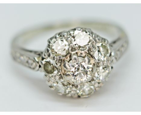An 18ct white gold diamond cluster ring, marked '18ct PLAT', gross wt. 4.4g, size L.  