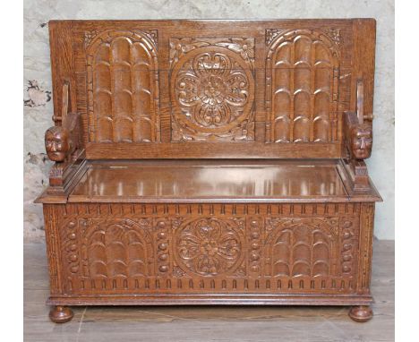 A carved oak monk's bench circa 1920, width 122cm, depth 53.5cm &amp; height 71cm.  