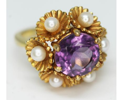 A 9ct gold ring set with an amethyst coloured stone and pearls, marked '9', gross wt. 7.9g, size N/O.  