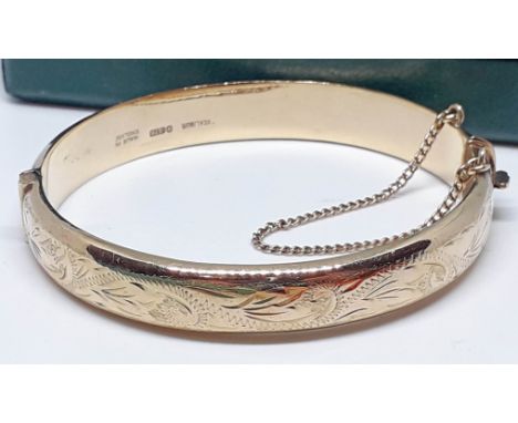 A hallmarked 9ct gold bangle 'Excalibur', wt. 13.3g, with box.  