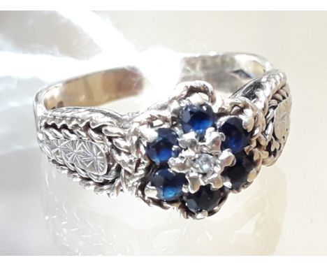 A hallmarked 9ct gold diamond sapphire cluster ring, gross wt. 3.1g.  