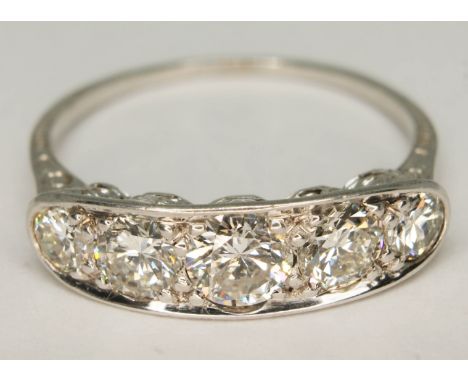 An Art Deco style five stone diamond ring, total approx. diamond wt. 1.46 carats, white metal band unmarked, gross wt. 2.9g, 