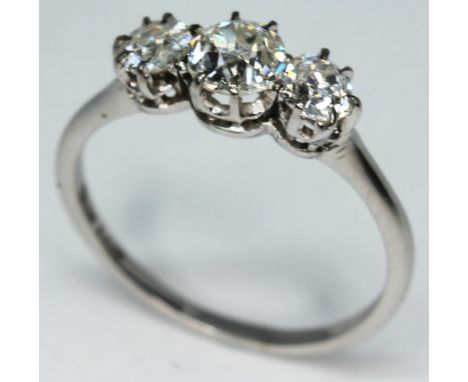 A three stone diamond ring, total approx. diamond wt. 0.95 carats, band marked 'W18ct', gross wt. 2.4g, size O.  Condition - 