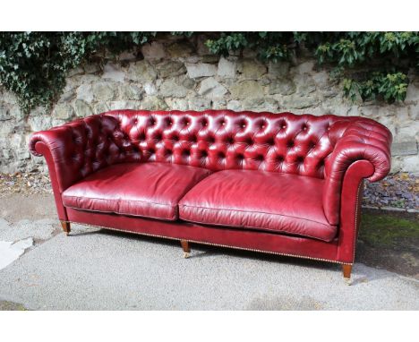 Howard & Sons, large modern oxblood buttoned leather upholstered Chesterfield sofa, raised on square tapering supports with b