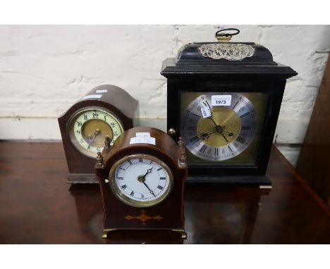 Reproduction ebonised two train mantel clock, small oak two train mantel clock and an Edwardian mahogany inlaid mantel clock,