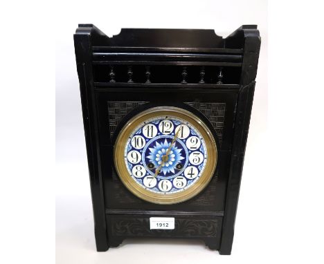 English ebonised Aesthetic movement mantel clock by Elkington & Co., the blue enamel dial with Arabic numerals, brass hands a