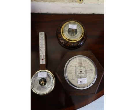 Art Deco oak aneroid barometer, inscribed S&M, stormoguide, together with another circular carved oak aneroid barometer and a
