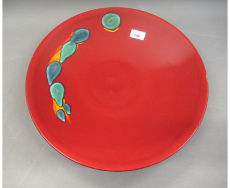 Poole pottery, large circular wall charger in Volcano pattern on a dark red ground, 16ins diameter 