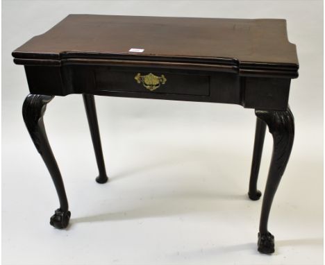 18th Century mahogany inverted breakfront fold-over card table, the shaped top above a single frieze drawer on acanthus carve