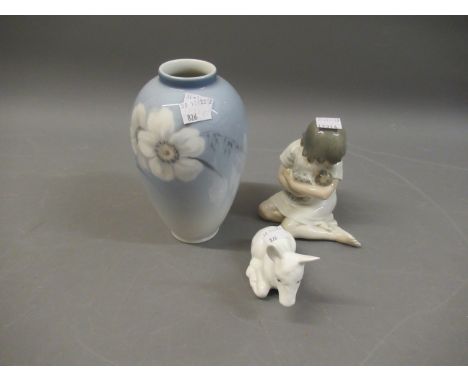 Royal Copenhagen figure of a girl cradling a doll, together with a Royal Copenhagen baluster form vase and a Coalport white g