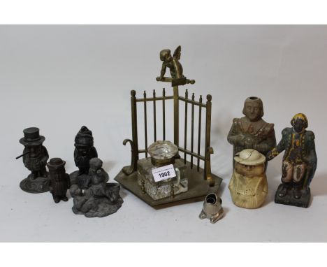 Brass inkwell surmounted by a figure of a cherub above a railing, together with a silvered metal figural mantel clock, a smal
