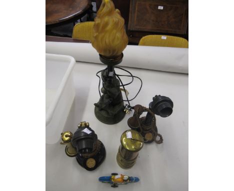 Two early 20th Century telephones PL30 and AK24, a reproduction miners lamp, tin plate push along toy and a modern patinated 