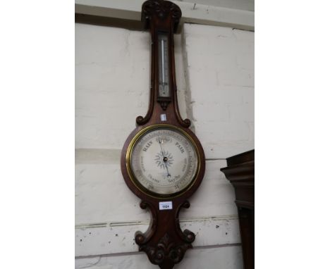 Late Victorian carved oak aneroid barometer/thermometer, the silvered dial inscribed Negretti and Zambra 