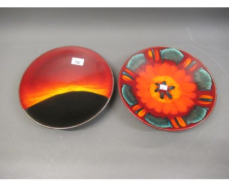 Two Poole pottery circular wall chargers in Eclipse and Volcano pattern, each 10.5ins diameter 