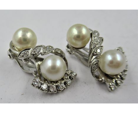 Pair of 14ct white gold cultured pearl and diamond set clip earrings of stylised floral design, approximate drop 21mm, 7.8g 