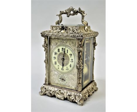 Fine quality late 19th / early 20th Century cast and silvered brass cased carriage clock, the ornate case with swing handle a