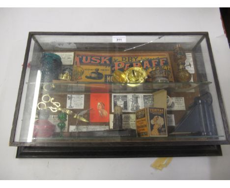Wall mounted display cabinet containing a quantity of various oil lamp related ephemera 