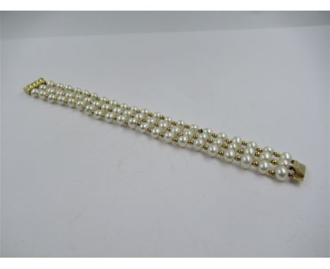 9ct Yellow gold mounted and cultured pearl three strand bracelet in fitted box 