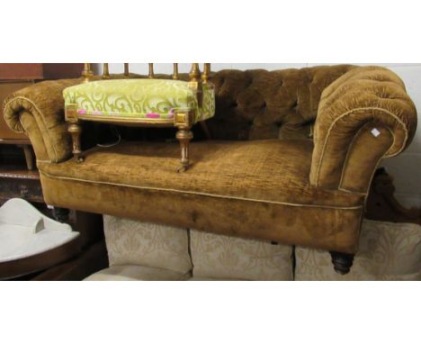 Small Victorian buttoned velvet upholstered Chesterfield sofa with a single drop-end, raised on low turned supports, 68ins wi