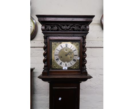 Oak longcase clock with a rectangular carved pierced and barley twist hood above a rectangular panelled door with bullseye an