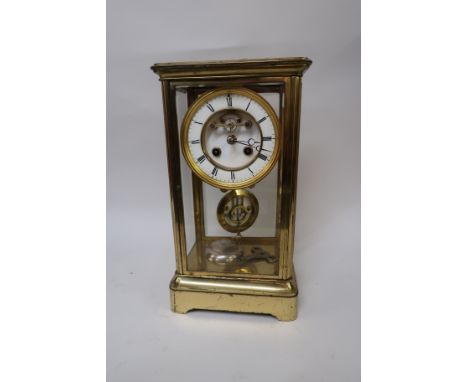 Late 19th Century gilt brass four glass library clock, the enamel dial with Roman numerals and two train movement with visibl