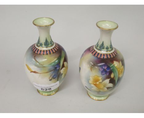 Pair of small Royal Worcester baluster form vases, painted with daffodils and violets, printed marks in green, date code for 