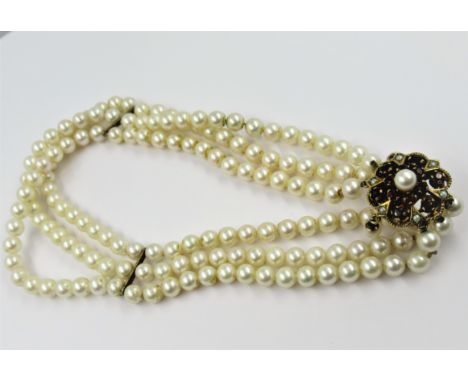 Triple row uniform cultured pearl choker with 9ct gold garnet and cultured pearl set clasp with drop, 33.5cms 