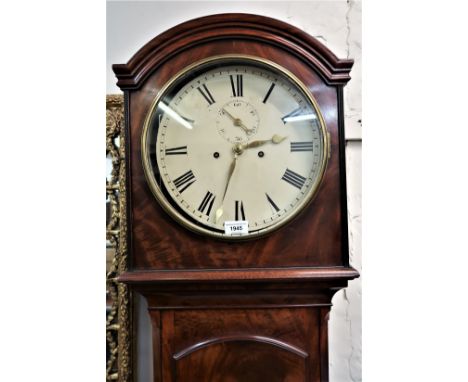 George III mahogany longcase clock, the arched hood above an arched door raised on bracket feet, the circular enamel dial wit