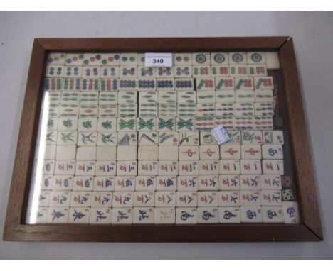 Mahogany box with clear perspex top containing a quantity of various bone and bamboo mahjong pieces, dice etc 