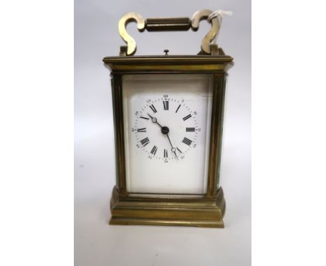 Late 19th / early 20th Century carriage clock, the brass case with bow end panels, enamel dial with Arabic and Roman numerals