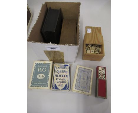 Two boxed sets of bone and ebony dominoes, various packs of cards and a miniature boxed set of bone dominoes 