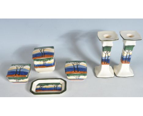 A 1930's Art Deco Royal Doulton ceramic dressing table set decorated with stylised trees comprising of a pair of candle stick